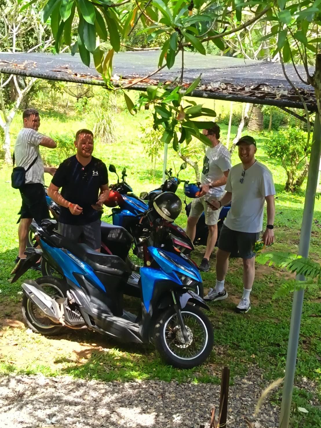 Travelers parking motorbikes at MaeKung Cafe Krabi garden